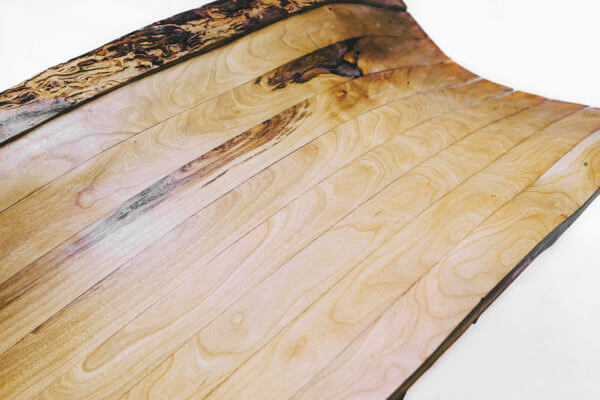 Wood grain and bark edges provide process narrative and clarify zero waste concept.